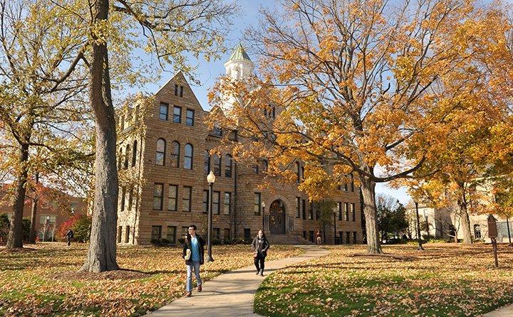 Students walk the historic BW campus in autumn. 